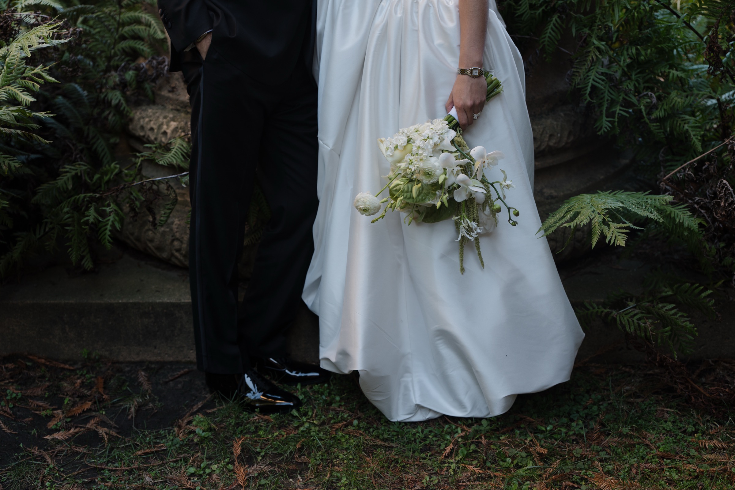 Bride and groom detail with bouquet